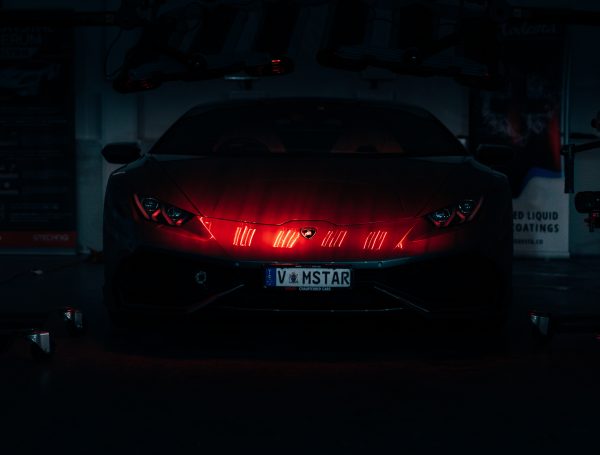 Lamborghini Aventador under infrared (IR) lights, with the vehicle’s surface curing after a detailing treatment.