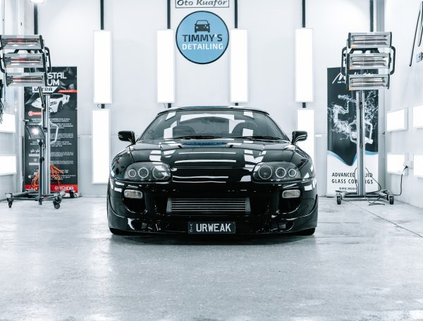 Finished black Toyota Supra in a studio, showcasing a glossy and well-maintained exterior.