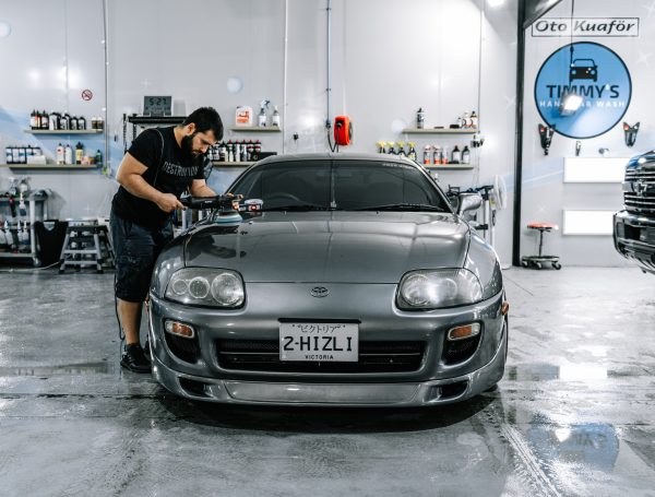 oyota Supra undergoing paint correction, with visible improvements to the vehicle’s paintwork, showcasing a smoother and more refined finish