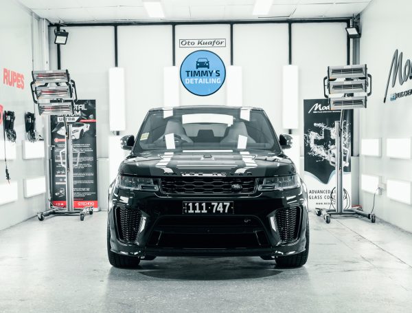 Range Rover Sport SVR displayed in a studio, showcasing its sleek design and polished finish under studio lighting.