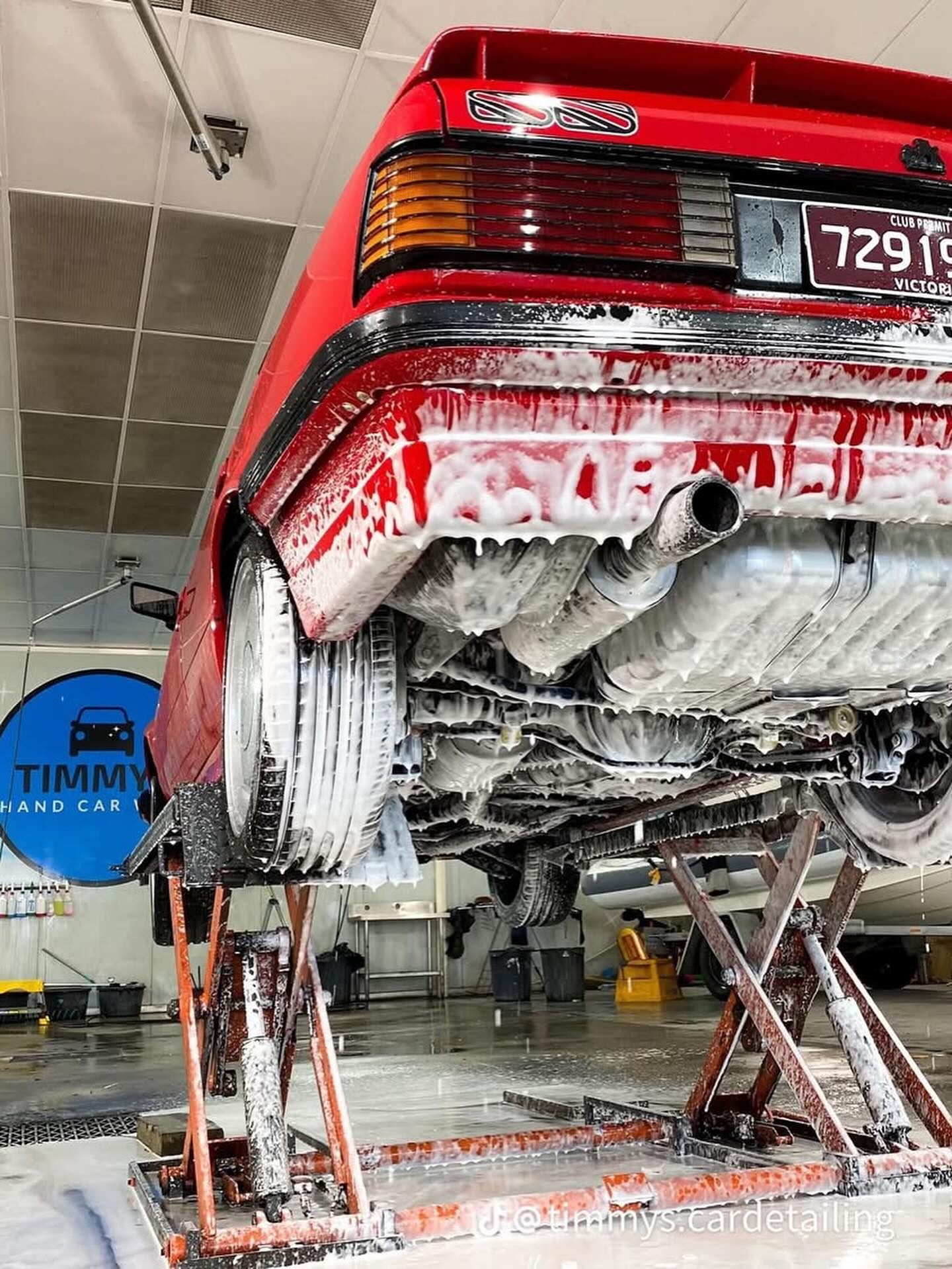 Car on hoist during undercarriage wash at Timmys Detailing Melbourne